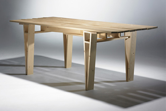 A four-legged table with a wide flat top and legs that start narrow and widen as they approach the top. Their faces are hollow.