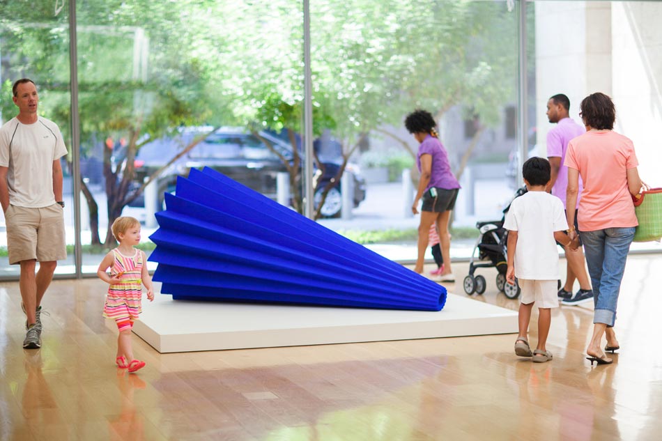 Families walk near a sculpture by Anish Kapoor