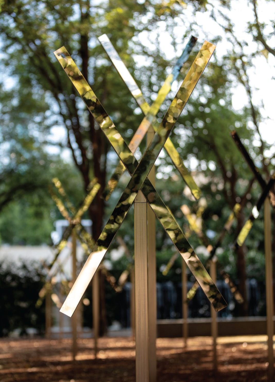 Mirrored x-shaped installations sit atop stainless steel posts marking the route of an underground stream in the Nasher Garden.