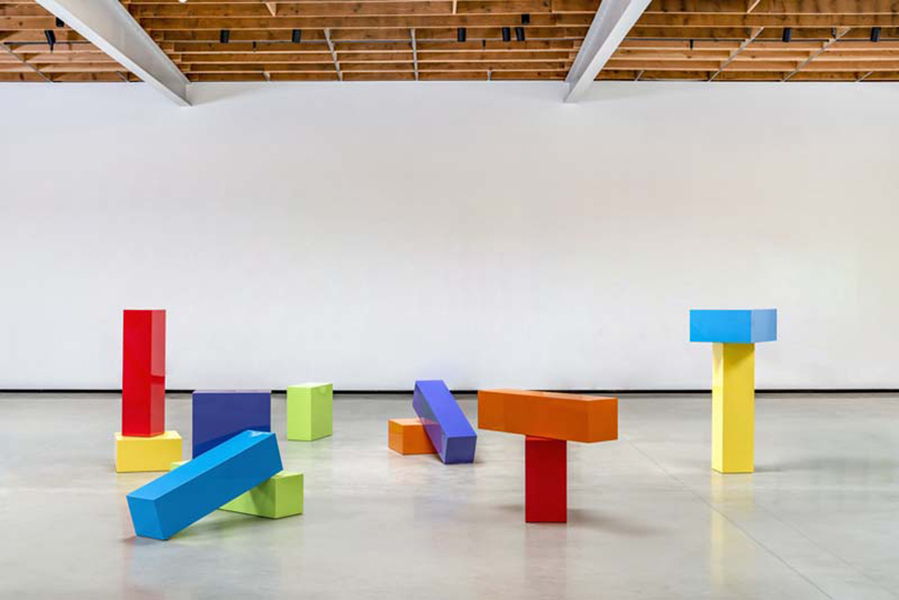 Large brightly colored blocks scattered on a gallery floor