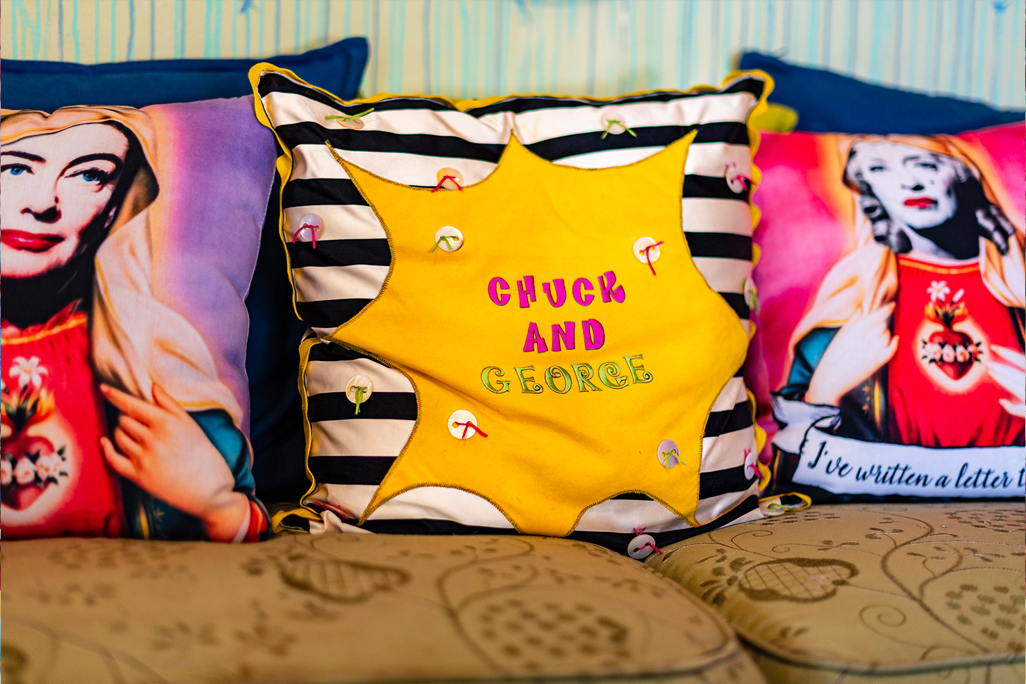 colorful pillow with chuck and george written in embroidery 