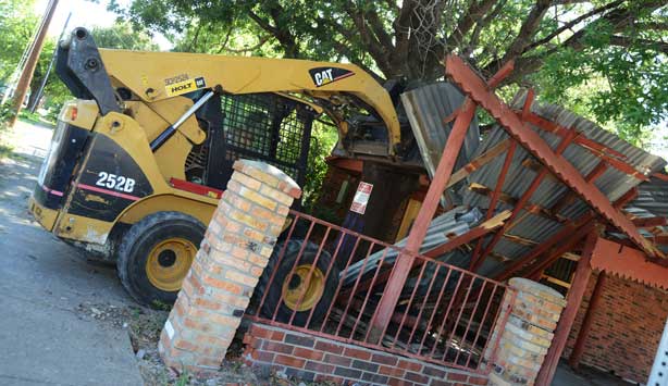 Bulldozer knocks down Oak Cliff house during installation of Lara Almarcegui’s artwork, Buried House