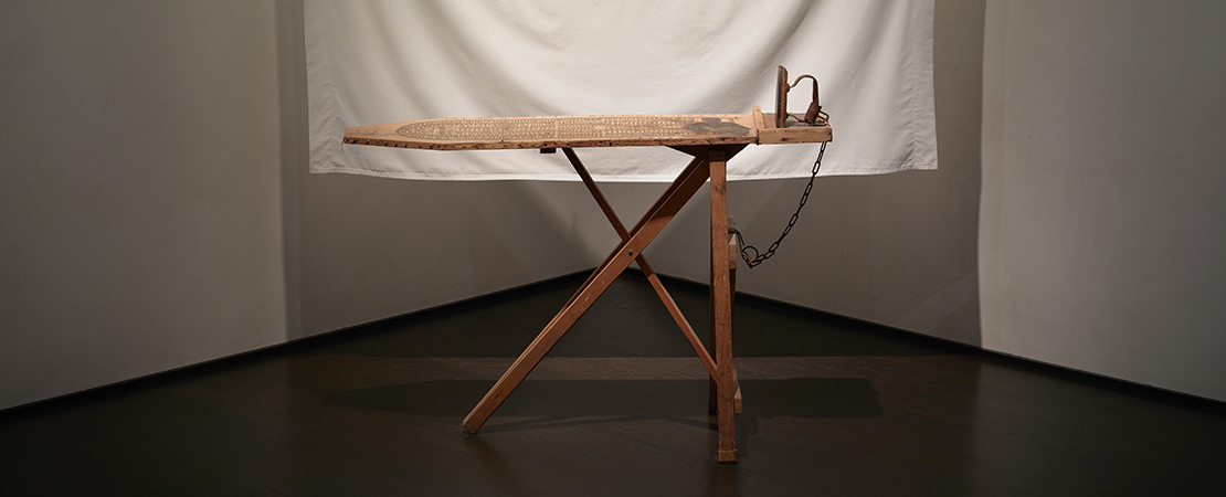 Betye Saar, I’ll Bend But I Will Not Break, 1998, Mixed media tableau: vintage ironing board, flat iron, metal chin, white bed sheet, six wooden clothespins, cotton, clothesline and one rope hook, 80 x 96 x 36 in (203.2 x 243.8 x 91.4 cm), Los Angeles County Museum of Art, Gift of Lynda and Stewart Resnick through the 2018 Collectors Committee, © Betye Saar