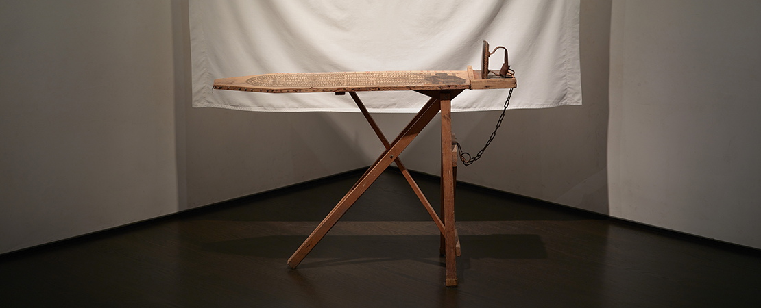 Betye Saar, I’ll Bend But I Will Not Break, 1998, Mixed media tableau: vintage ironing board, flat iron, metal chin, white bed sheet, six wooden clothespins, cotton, clothesline and one rope hook, 80 x 96 x 36 in (203.2 x 243.8 x 91.4 cm), Los Angeles County Museum of Art, Gift of Lynda and Stewart Resnick through the 2018 Collectors Committee, © Betye Saar