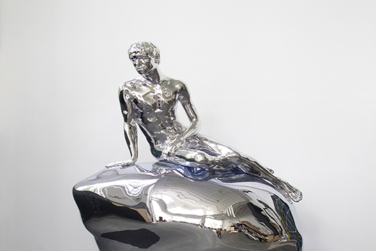 A silver sculpture titled He by Elmgreen & Dragset