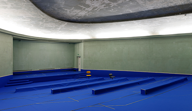 Picture of an empty room with blue tarp on the floor and circular room
