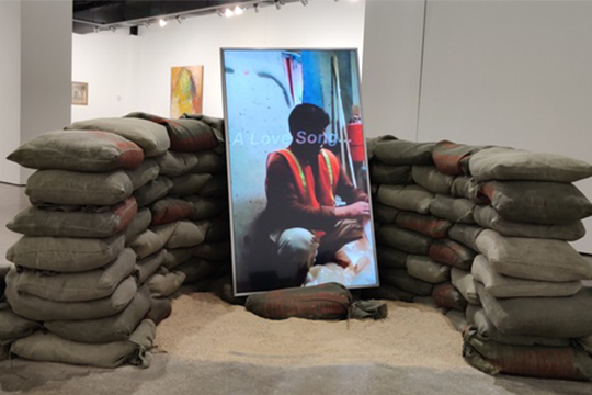 Goran Maric, 'Within the Horizon of the Common,' 2020. Installation, silkscreened military grade sandbags, video, 100" x 100" x 35". Courtesy Goran Maric