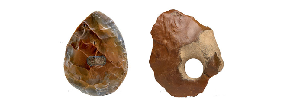 Two brown oval handaxes, the left is more textured and the right has a hole