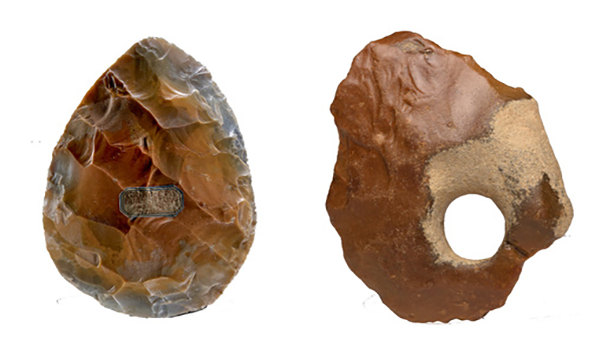 Two brown oval handaxes, the left is more textured and the right has a hole