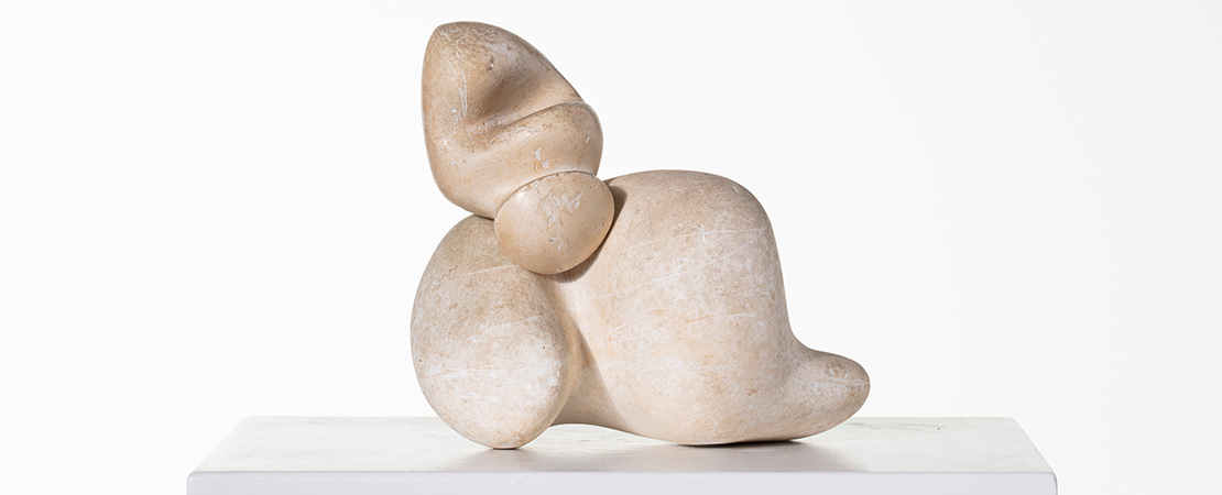 Image of Jean (Hans) Arp, "Shell and Head", 1933, a plaster sculpture on a podium.