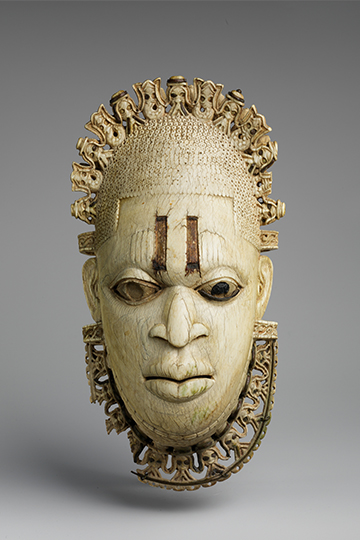 Edo Artist, Queen Mother Pendant Mask: Iyoba, 16th century. Ivory, iron, copper, 9 3/8 x 5 x 2 1/2 in. (23.8 x 12.7 x 6.4 cm). The Michael C. Rockefeller Memorial Collection, Gift of Nelson A. Rockefeller, 1972. The Metropolitan Museum of Art. 