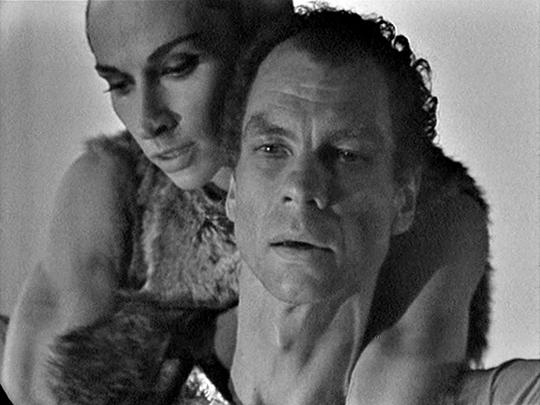 Close up of two dancers embracing in black and white