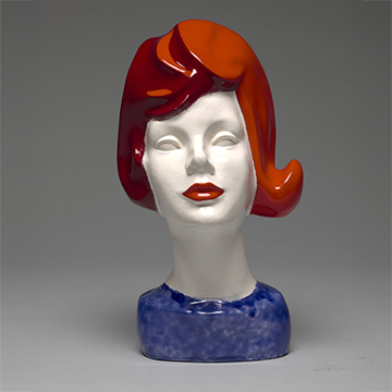 White ceramic sculpture of a woman's head with hair and lips painted red and base painted blue White ceramic sculpture of a woman's head with hair and lips painted red and base painted blue