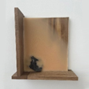 Image of wall-mounted sculpture made of wax and wood