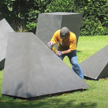 Conservator John Campbell works on a large sculpture
