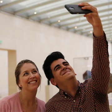 Curator Leigh Arnold takes a selfie with Ben Vega