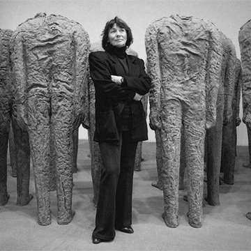 Artist Magdalena Abakanowicz stands among her sculptures