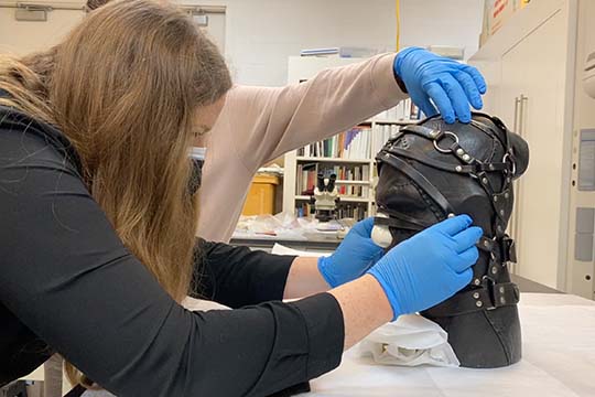 conservator claire taggart works on the nancy grossman leather head sculpture