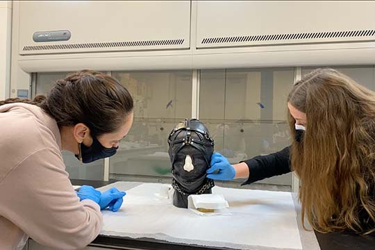 nasher conservation team examines nancy grossman head sculpture in the lab